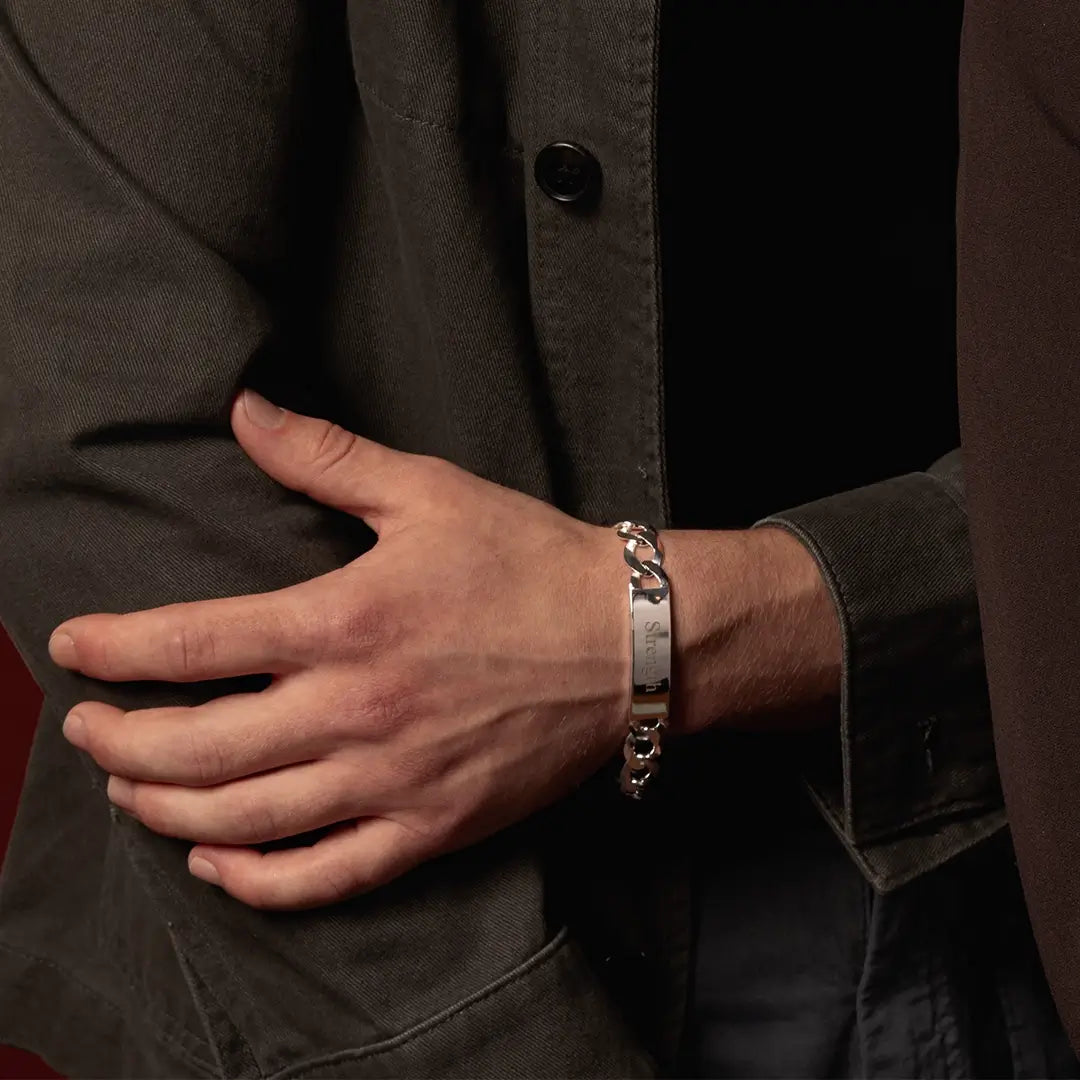Close-up of male model wearing an engraved sterling silver ID bracelet