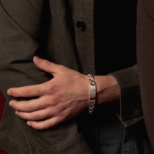 Close-up of male model wearing an engraved sterling silver ID bracelet