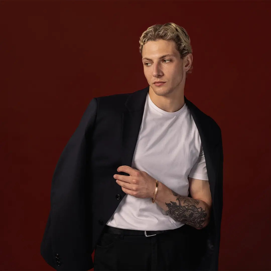 Male model wearing a handcrafted solid 9ct gold ID bracelet
