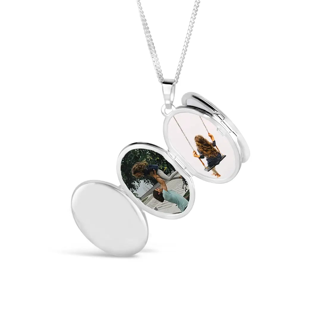 Sterling silver oval locket necklace open to display personalised family photographs inside, high-polish finish with removable photo frames on a silver chain.