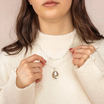 woman wearing Silver oval Necklace for ashes, memorial necklace, locket with one photo and ashes storage, silver curb chain, engraving, silver paperclip chain