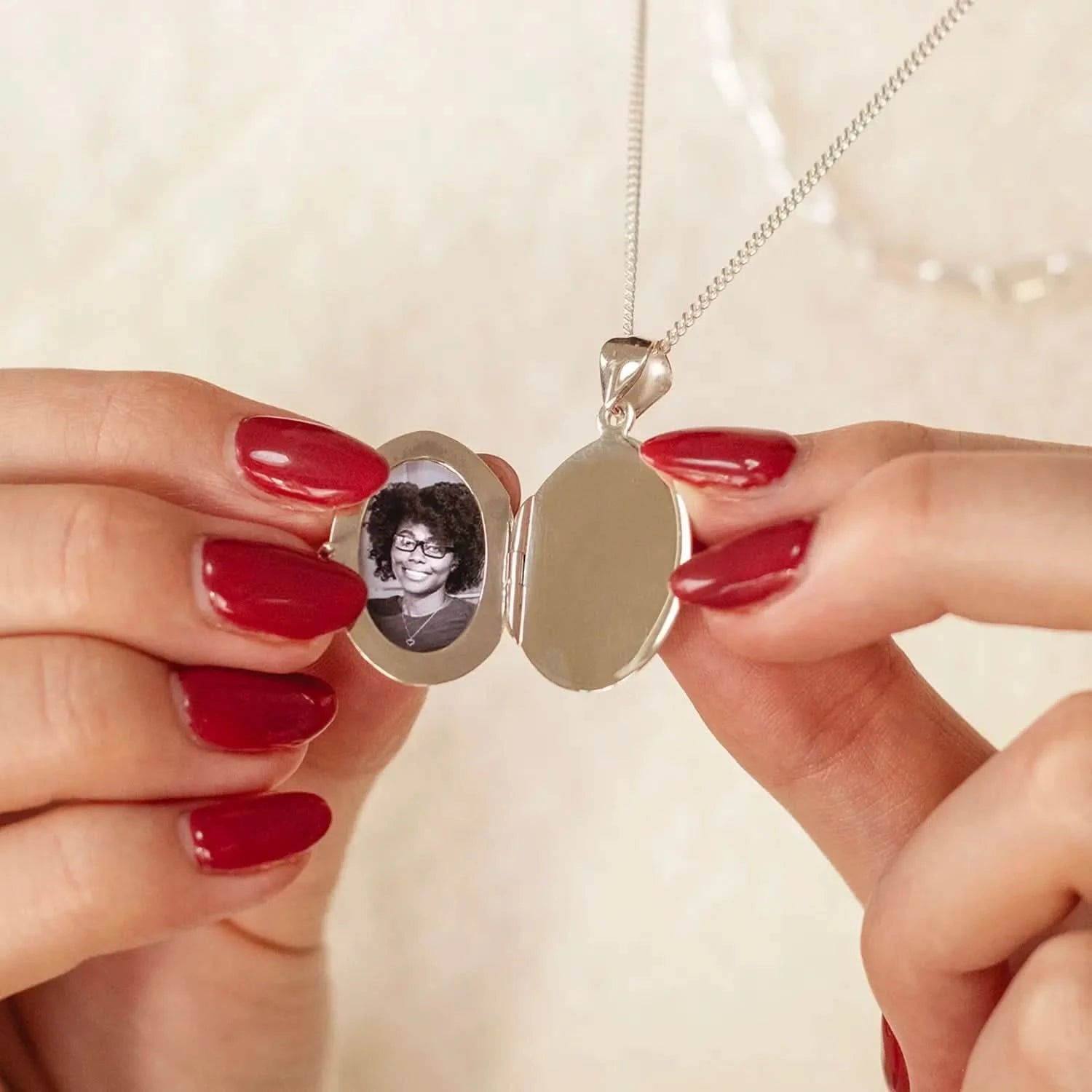 woman wearing Silver oval Necklace for ashes, memorial necklace, locket with one photo and ashes storage, silver curb chain, engraving, photo inside