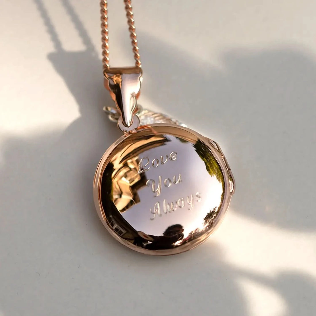 Rose gold round photo locket engraved with ‘Love You Always’ on chain