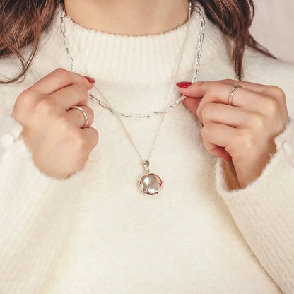 woman wearing Silver round Necklace for ashes, memorial necklace, locket with one photo and ashes storage, silver curb chain, engraving, silver paperclip chain