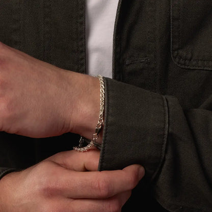 Close-up of sterling silver Spiga chain bracelet worn on the wrist