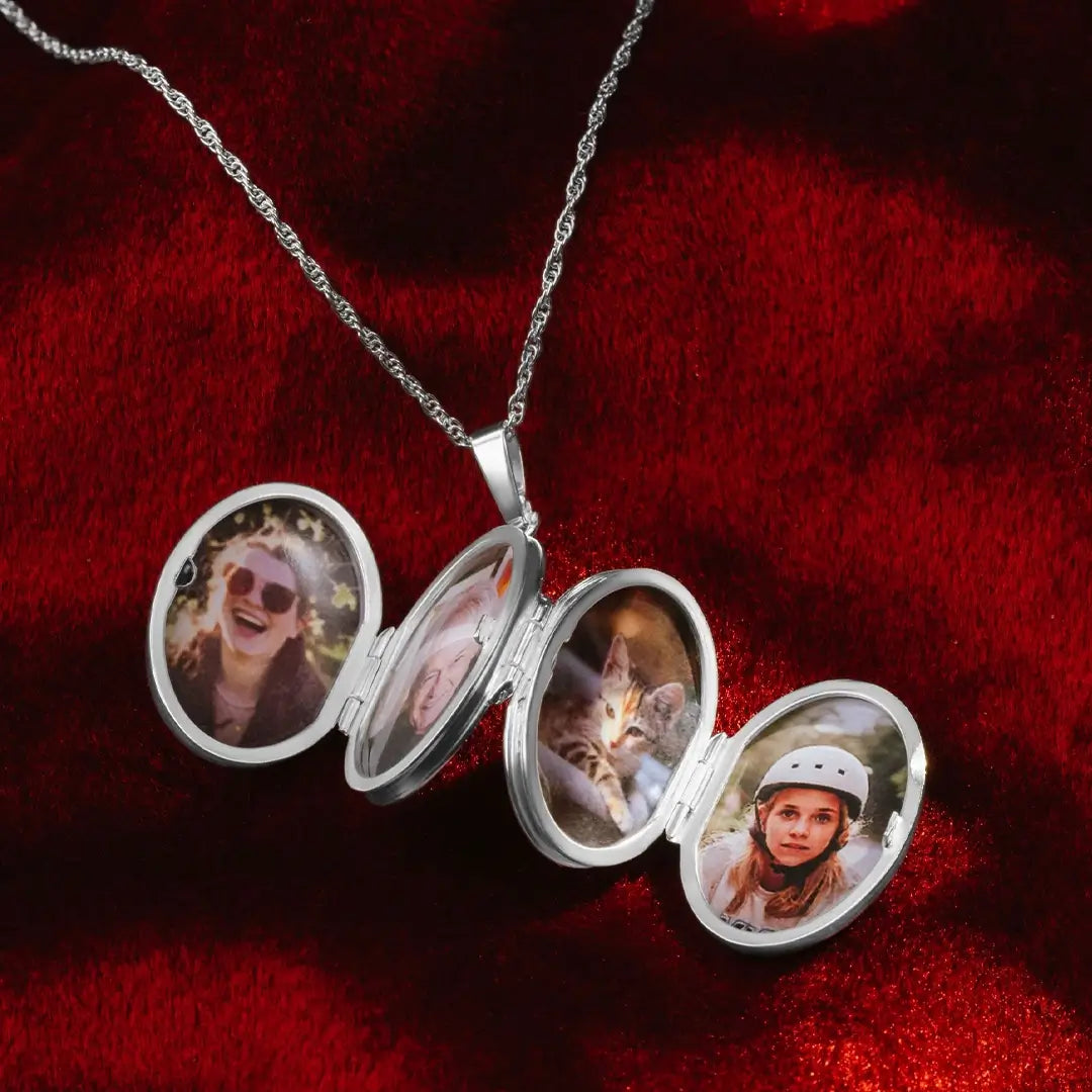 Sterling silver six-photo expanding oval locket necklace fully opened on a rich red velvet background, displaying personalised portrait and pet photographs inside polished oval frames on a silver chain.