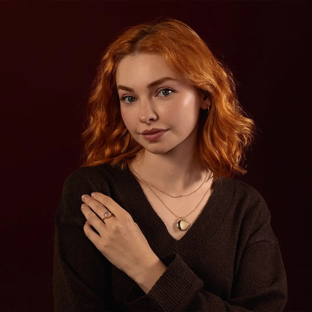 Model wearing a solid 9ct gold round locket necklace on a rope chain