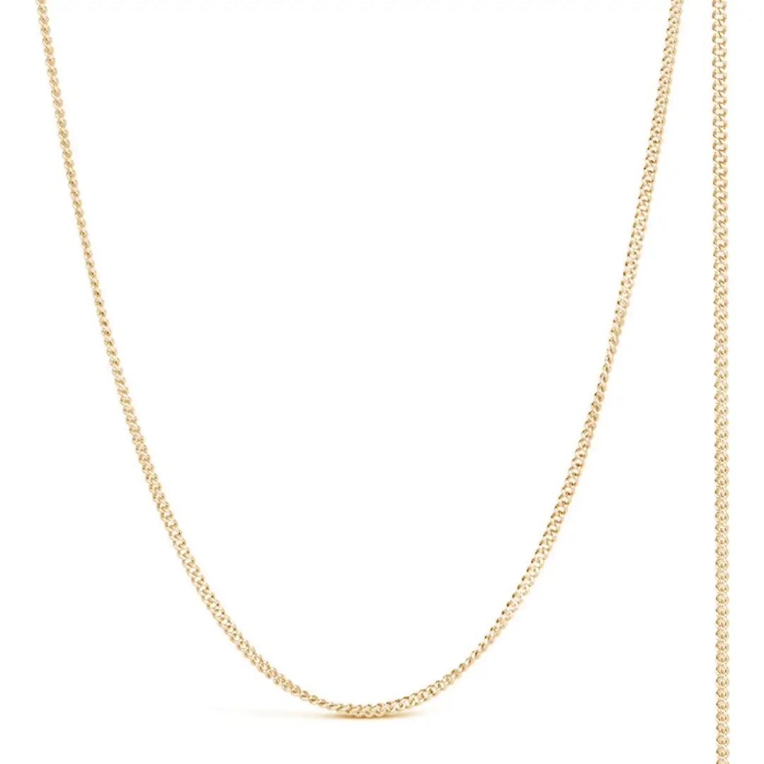 solid yellow gold curb chain on a white background.