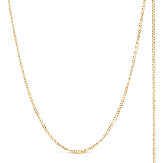 solid yellow gold curb chain on a white background.