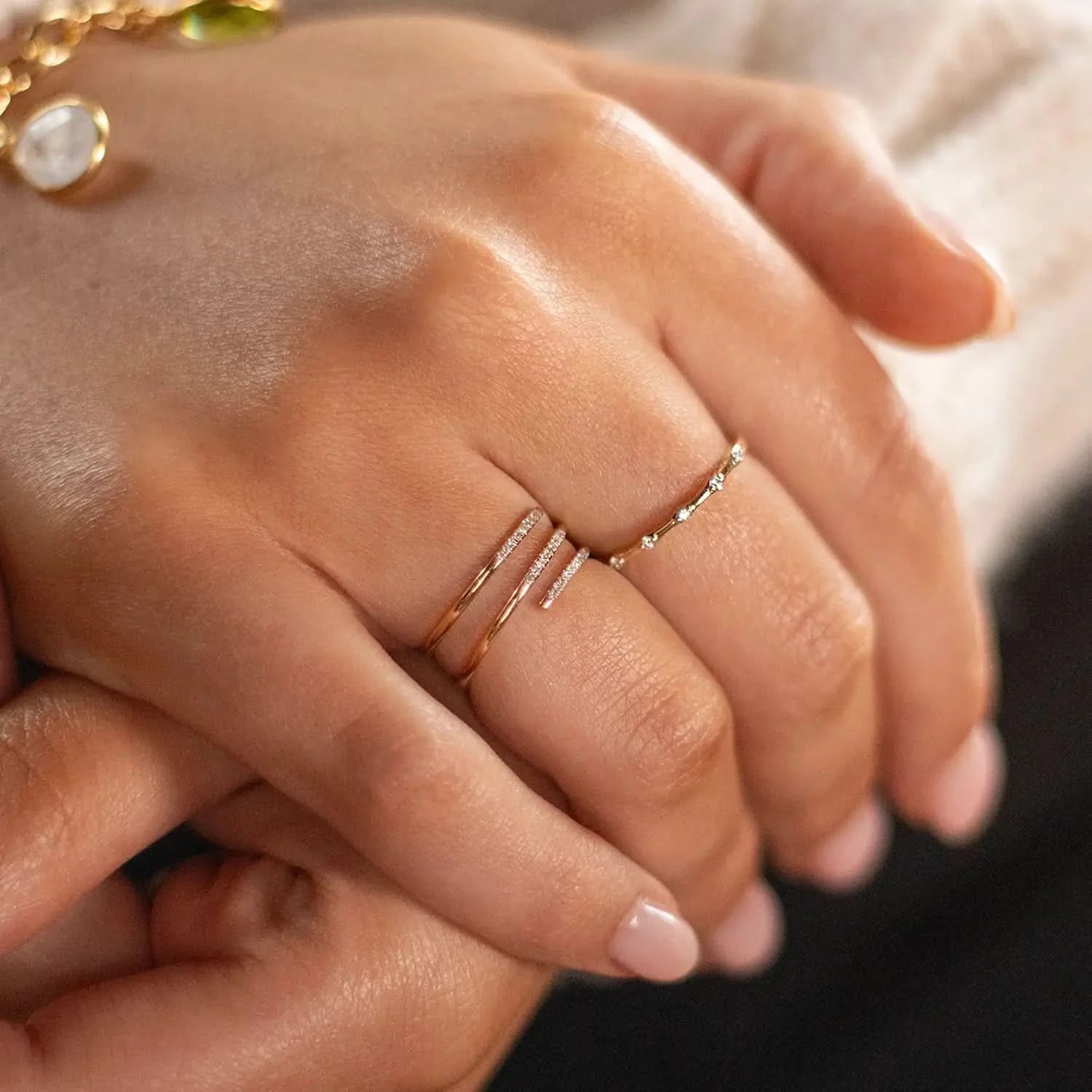 model wearing multi diamond spiral solid gold band ring
