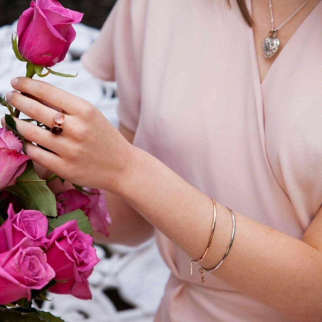 close up of model wearing two key bangles