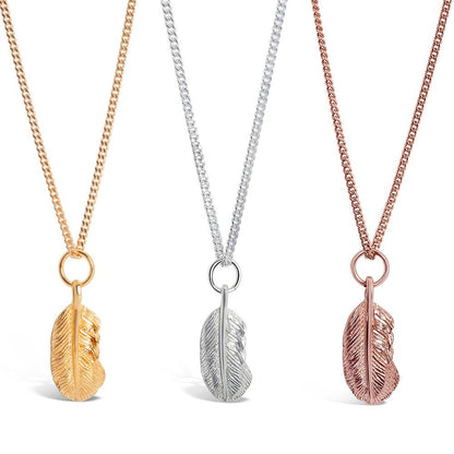 set of three feather pendants in gold, rose gold and silver