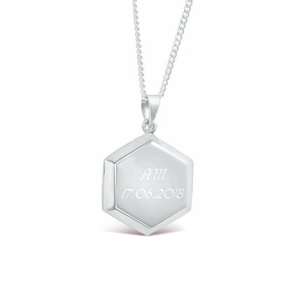men's hexagon locket in silver engraved with message on a white background 