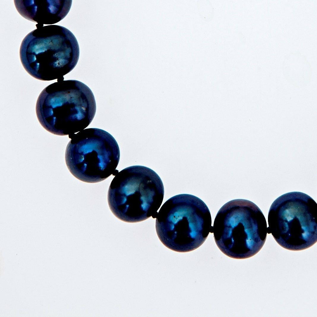 close up of classic pearl bracelet in midnight on a white background