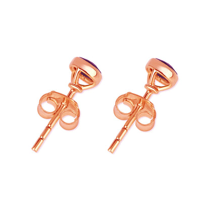 Garnet mini stud earrings in rose gold facing the back on a white background
