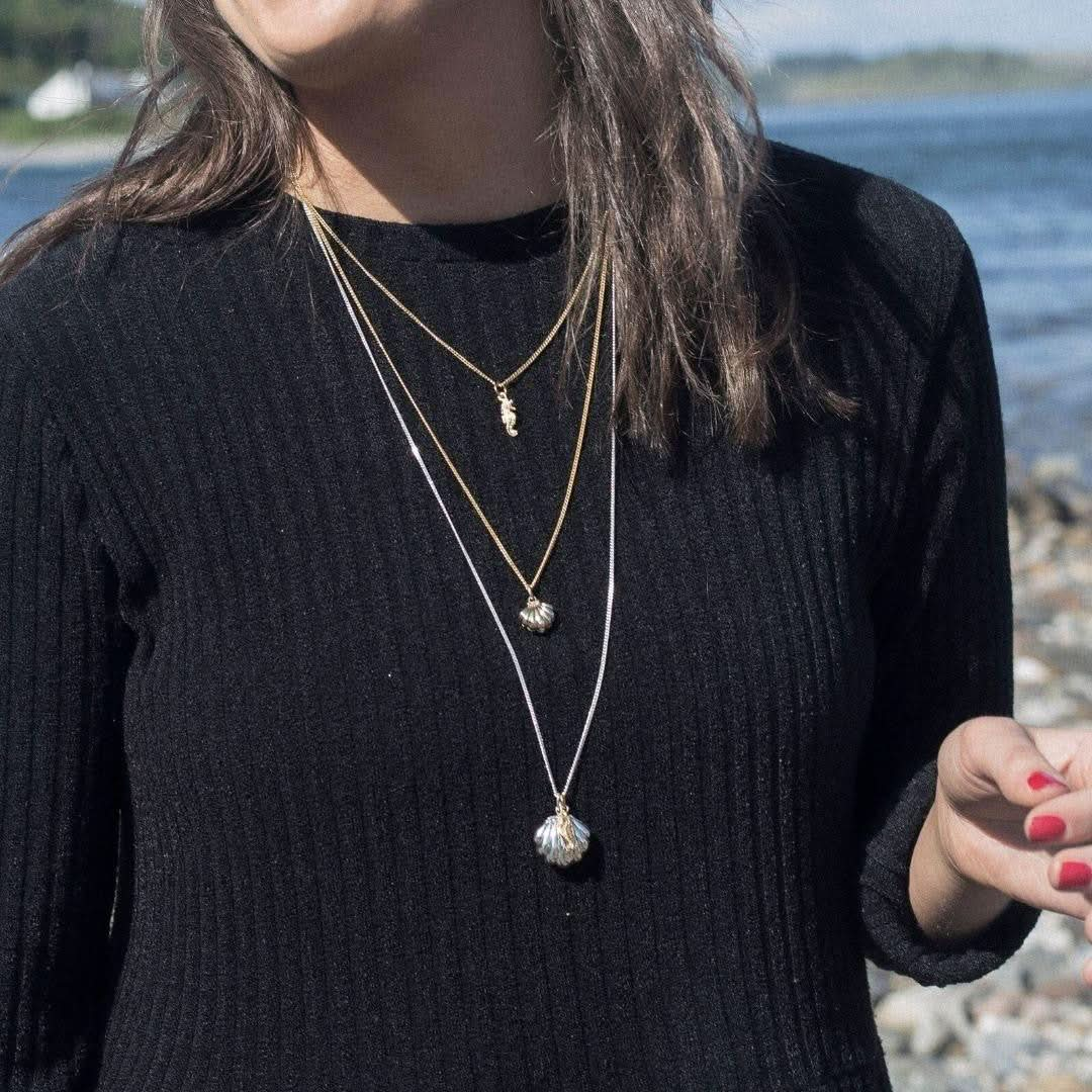 model wearing seahorse locket in silver