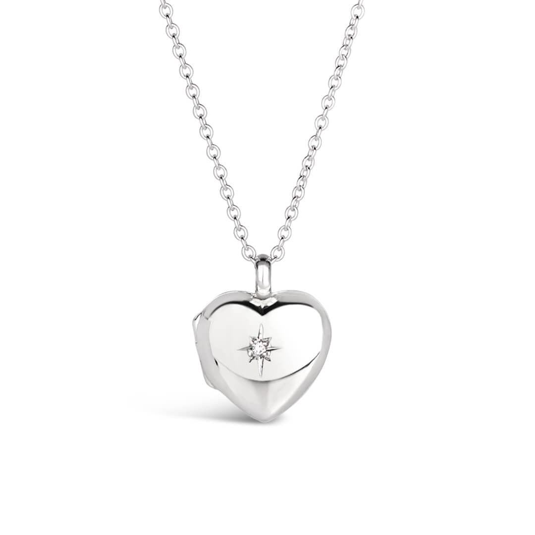 front perspective of a heart shaped locket in silver on a white background with a diamond decoration