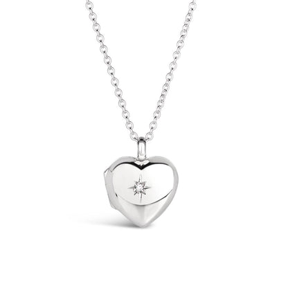 front perspective of a heart shaped locket in silver on a white background with a diamond decoration