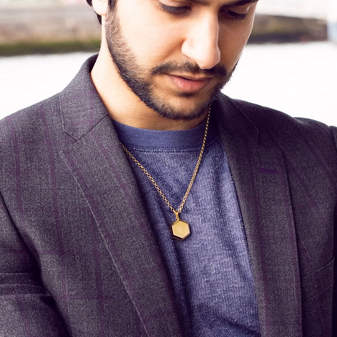 model wearing men's hexagon locket in gold
