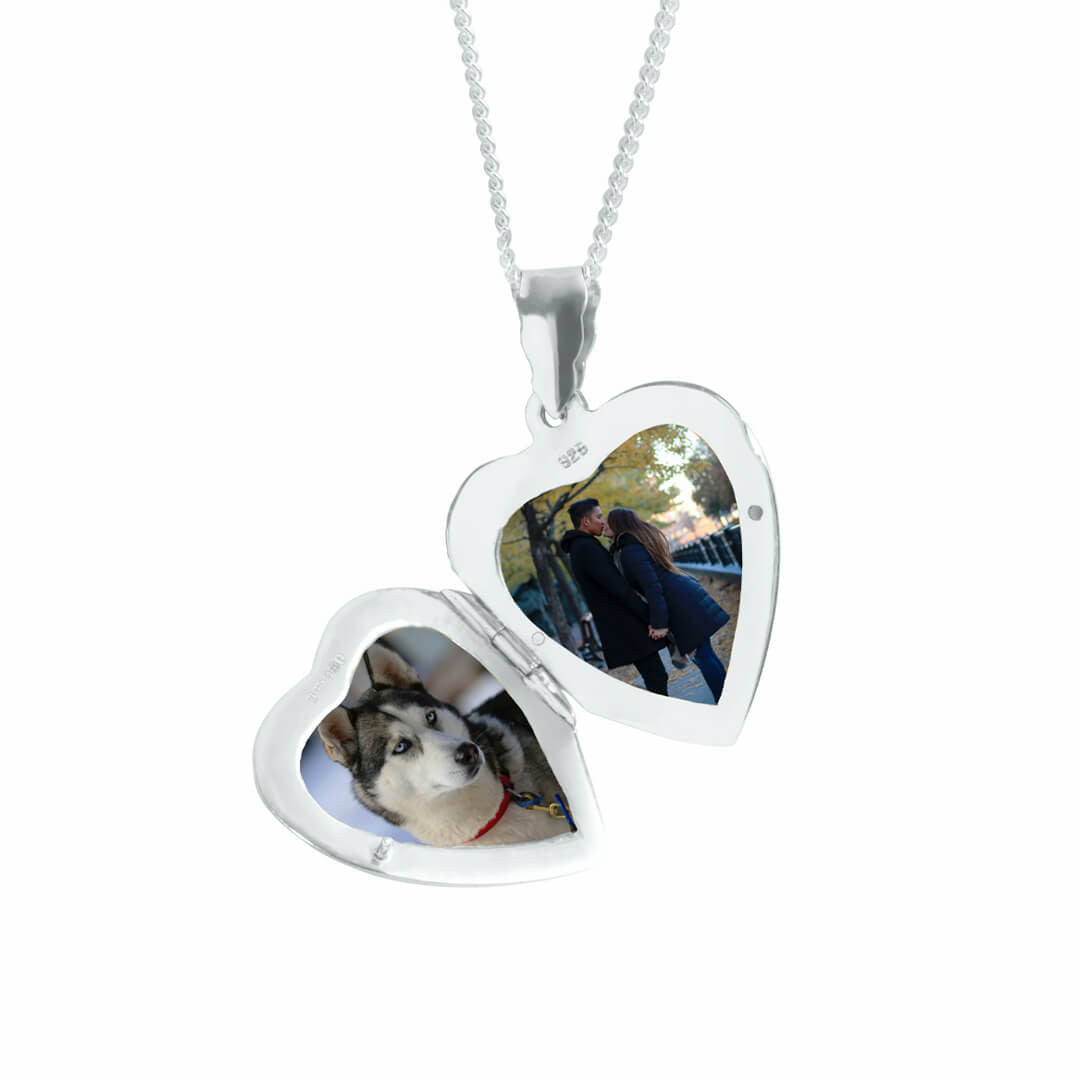 opened heart locket necklace with two photos inside on a white background 