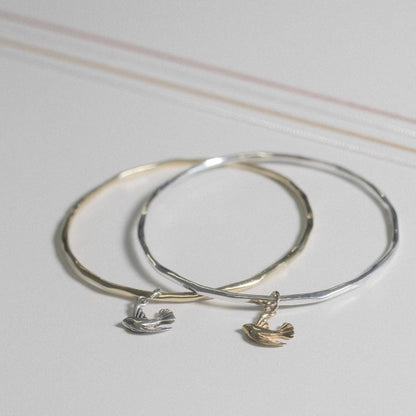 two bird bangles on a white background