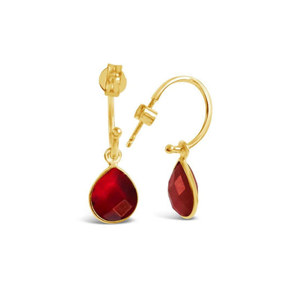 garnet drop hoop earrings in gold on a white background