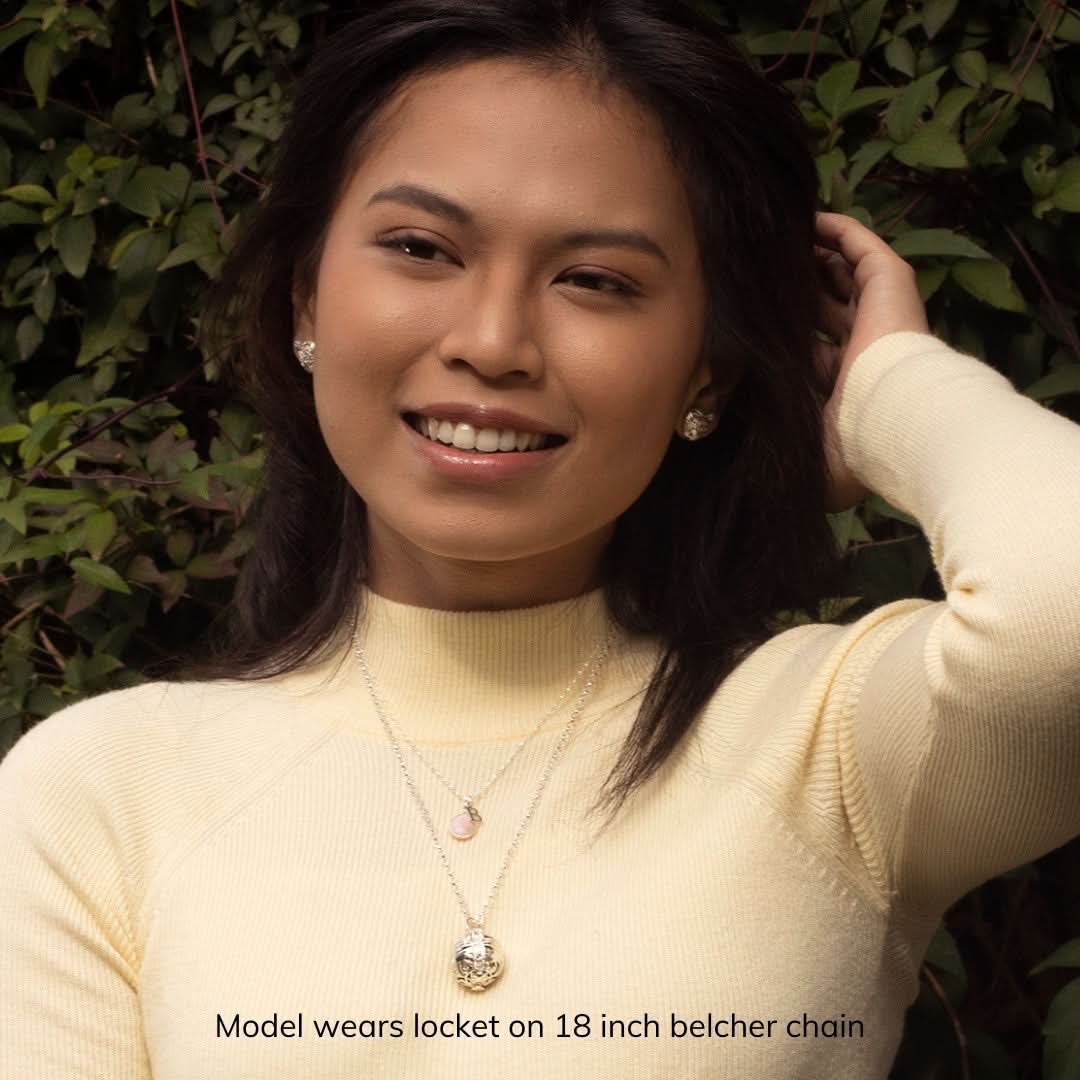 model in cream top wearing silver memory keeper locket on an 18 inch belcher chain
