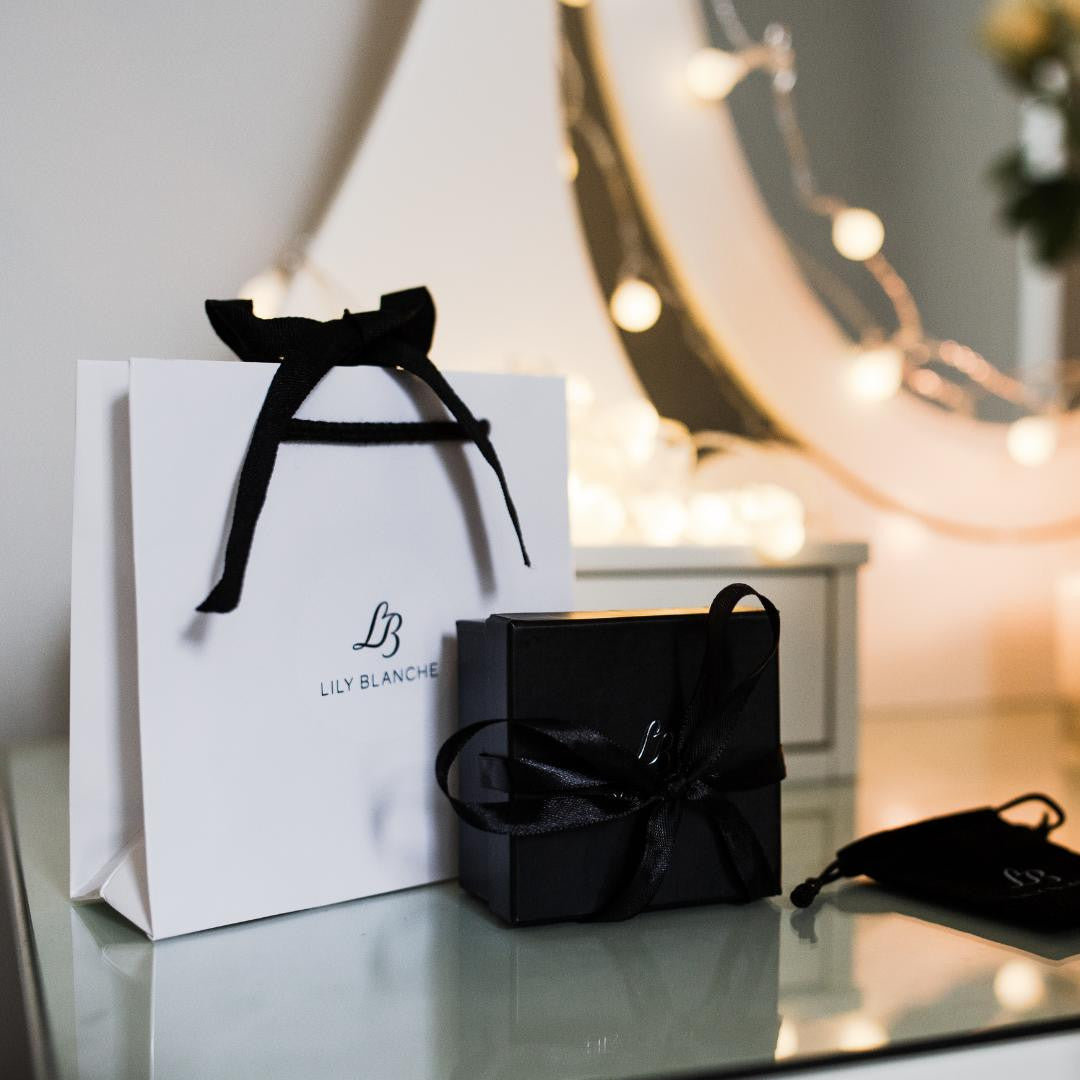 Lily Blanche white ribbon tied gift bag with black ribbon tied box