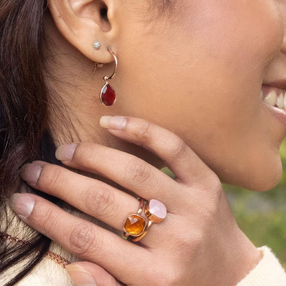 close up of model wearing rose quartz cocktail ring in rose gold 