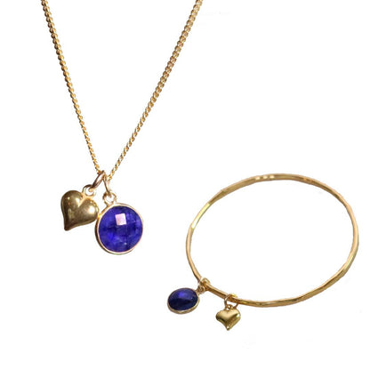 sapphire charm bangle and necklace with hearts attached on a white background
