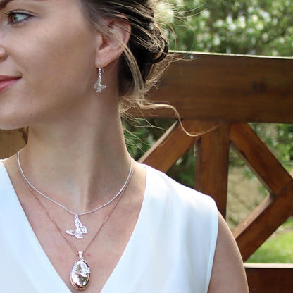 model wearing butterfly earrings in silver