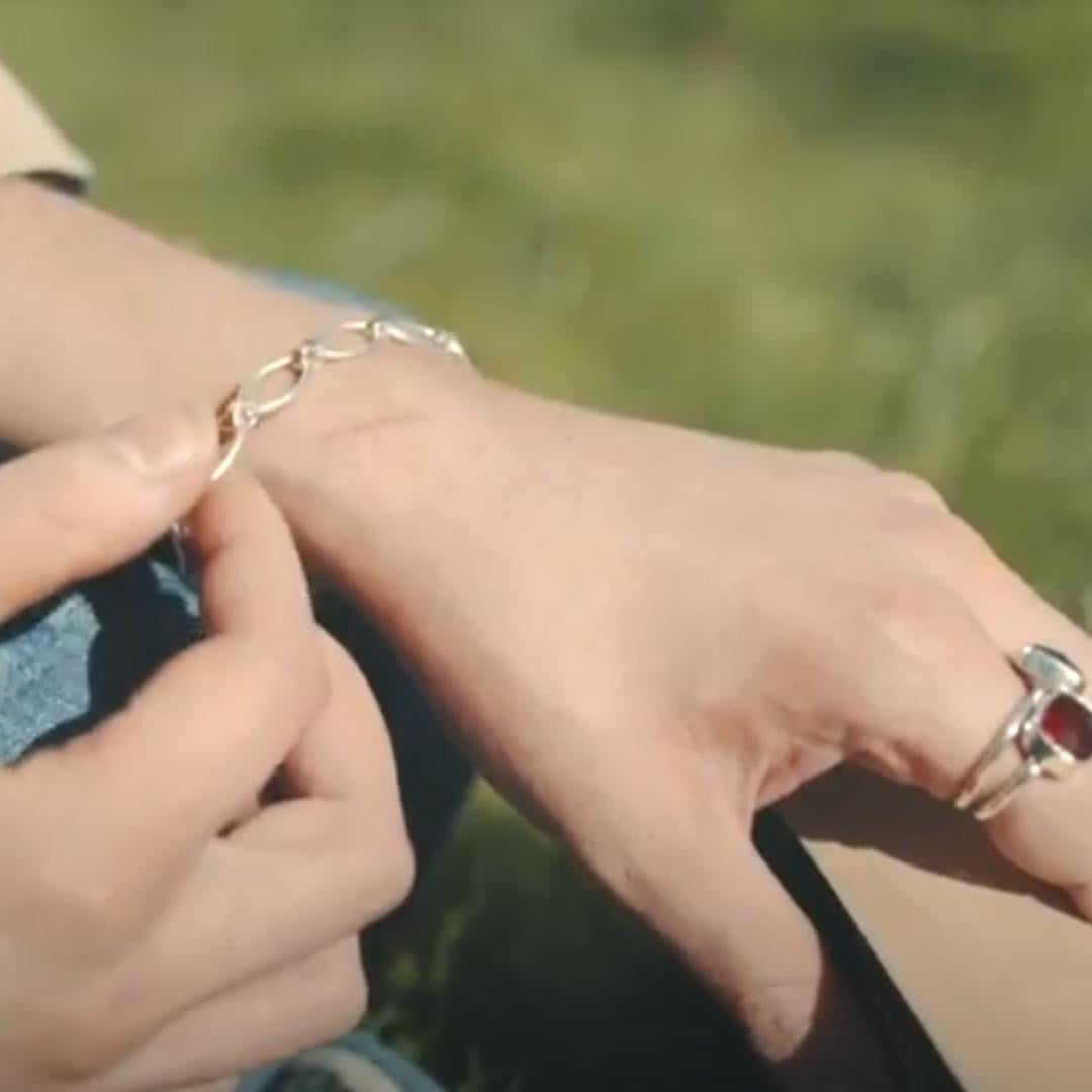 close up of model wearing link charm bracelet