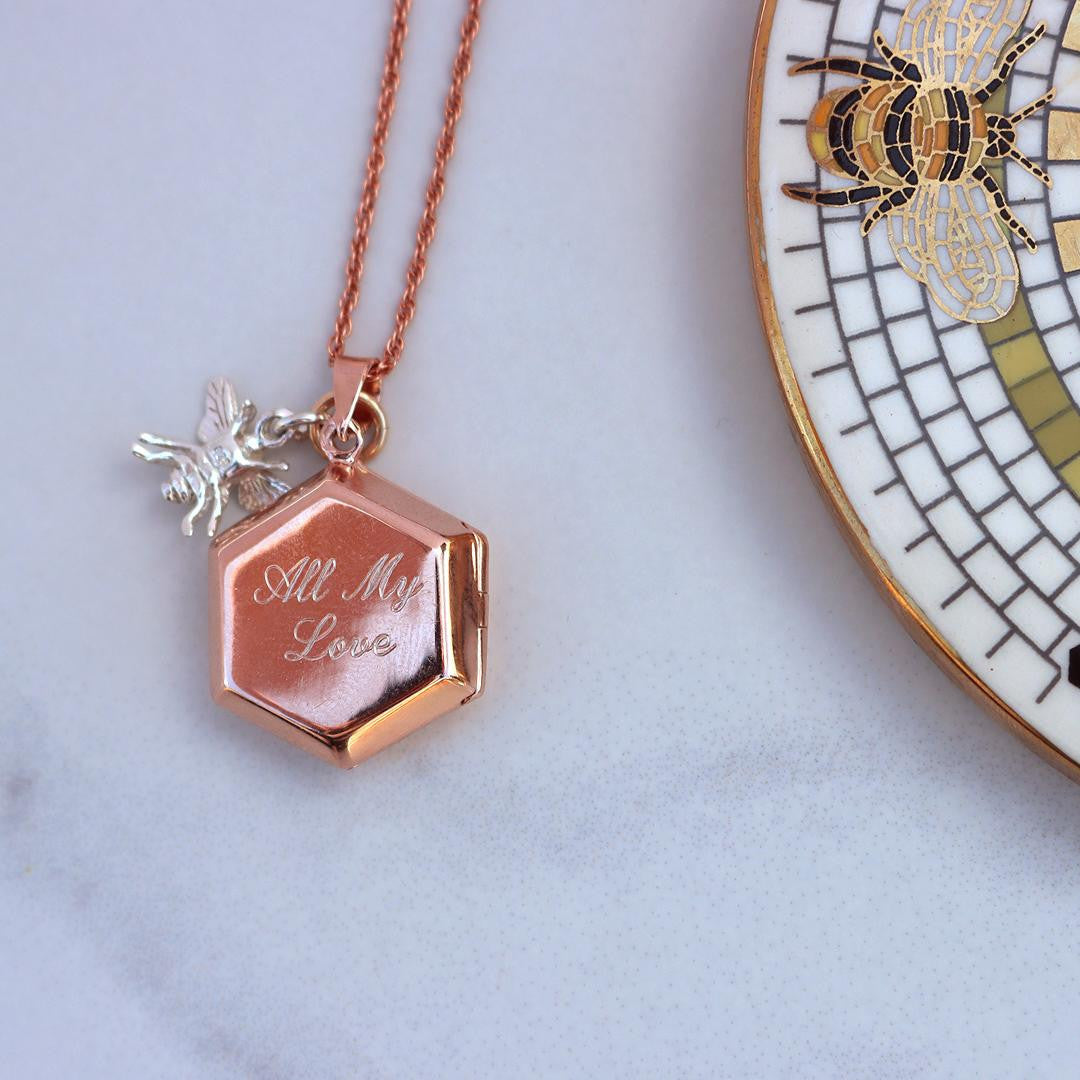 engraved locket in rose gold on a table