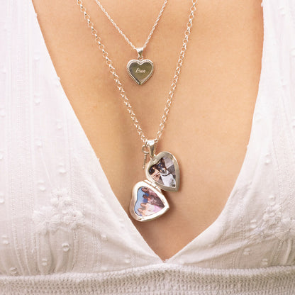 close up of model wearing opened heart locket necklace in silver 