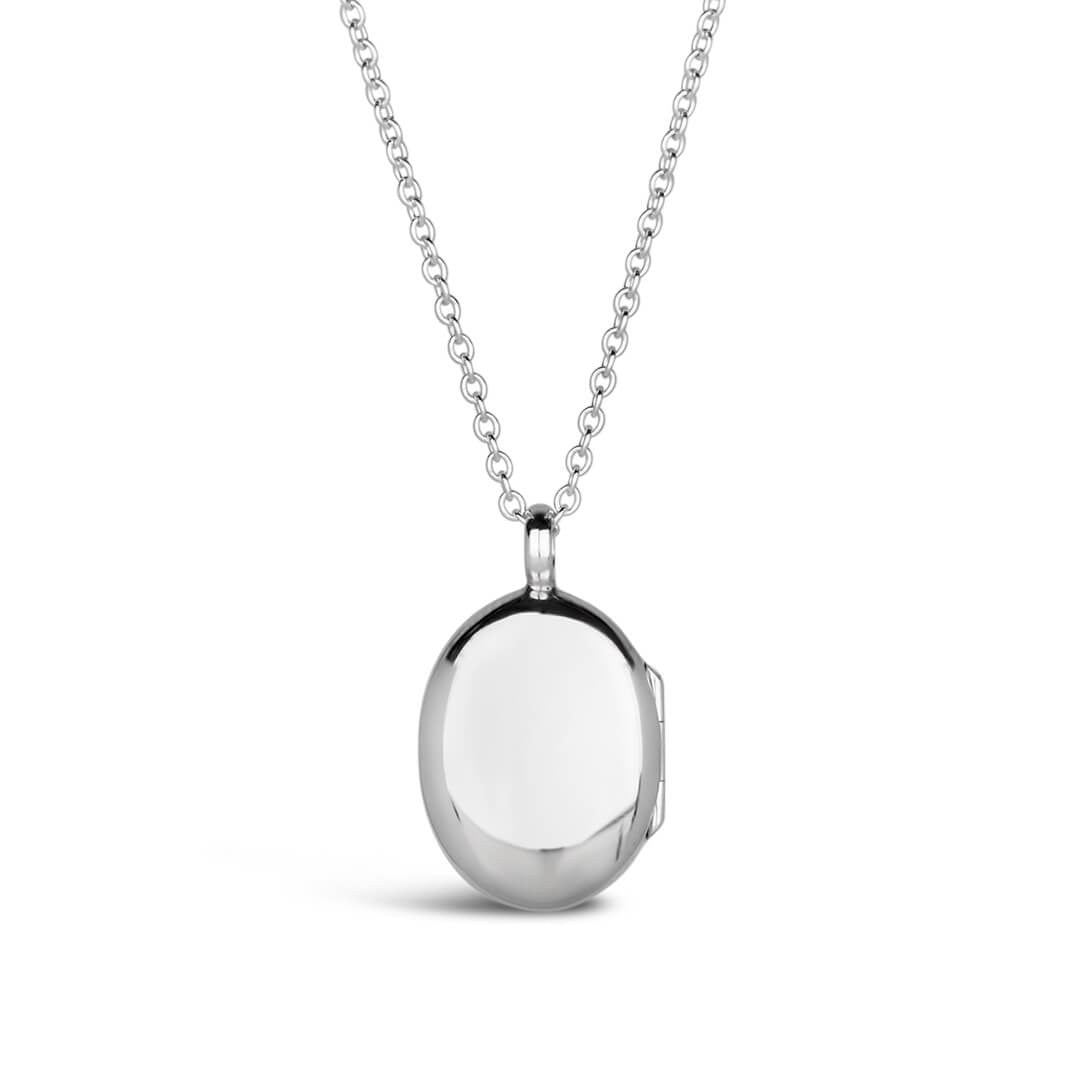 back off small oval diamond locket in silver on a white background
