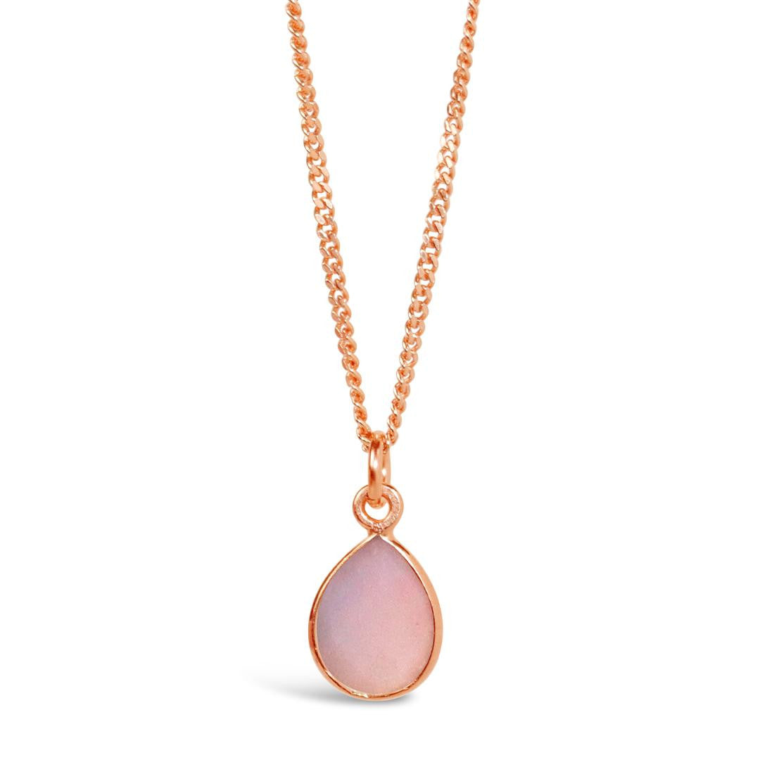 pink opal charm necklace in rose gold on a white background