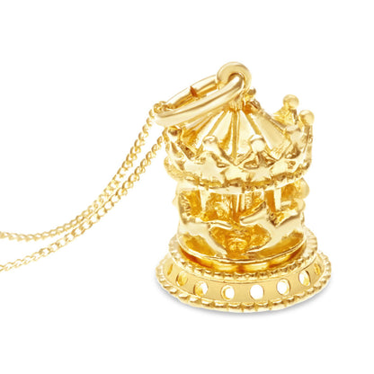 Close up of gold Charm Necklace featuring a crousel