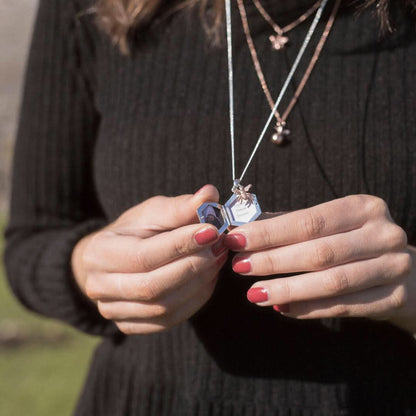 model wearing opened  locket in silver