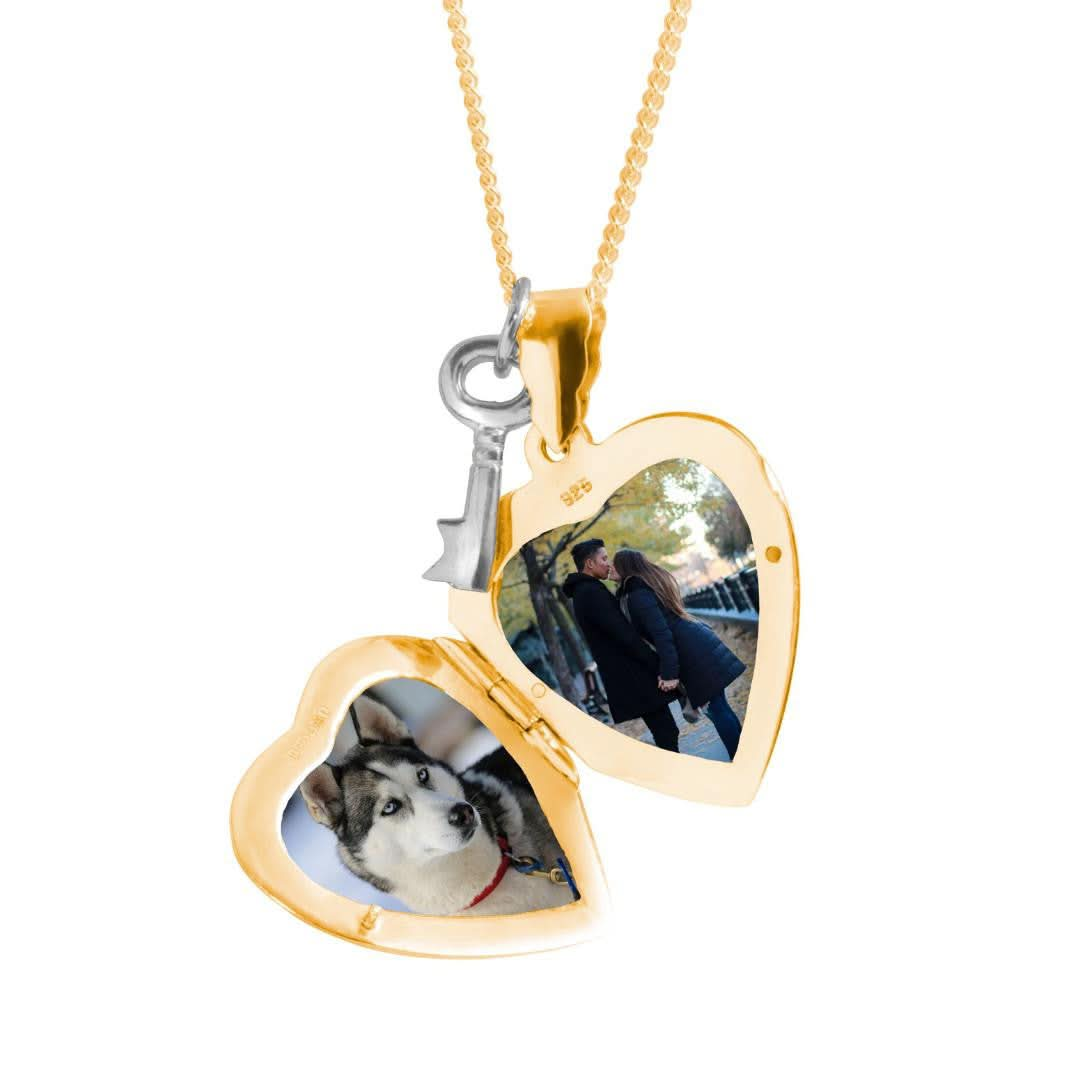 opened key locket in gold with family photos inside on a white background