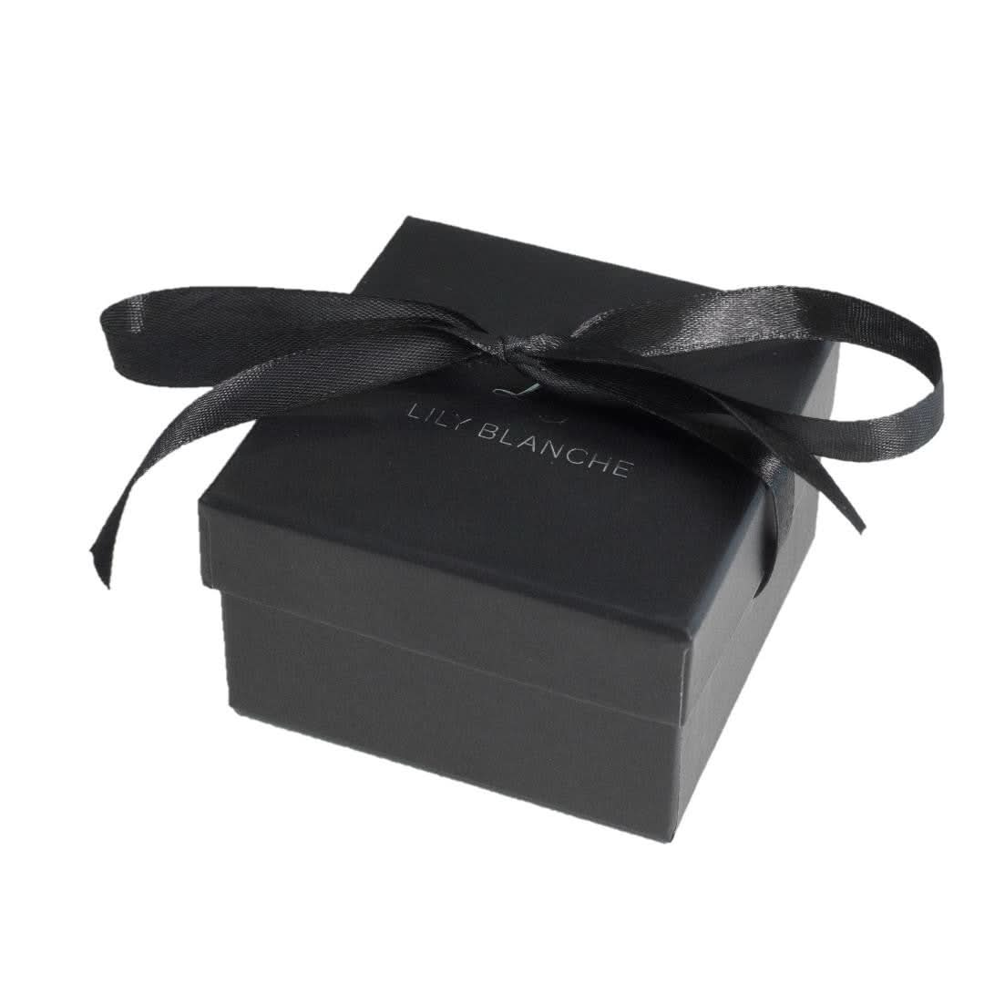 black ribbon-tied Lily Blanche gift box on a white background