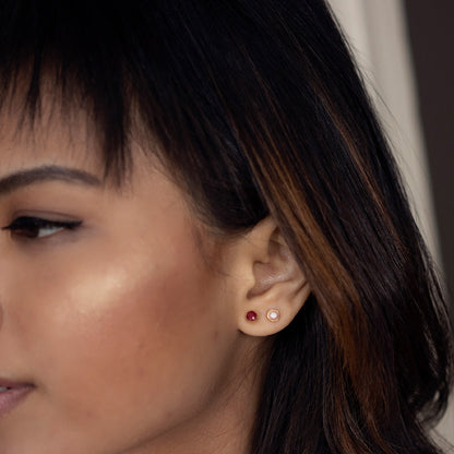 close up of model wearing pink opal mini stud earrings in silver
