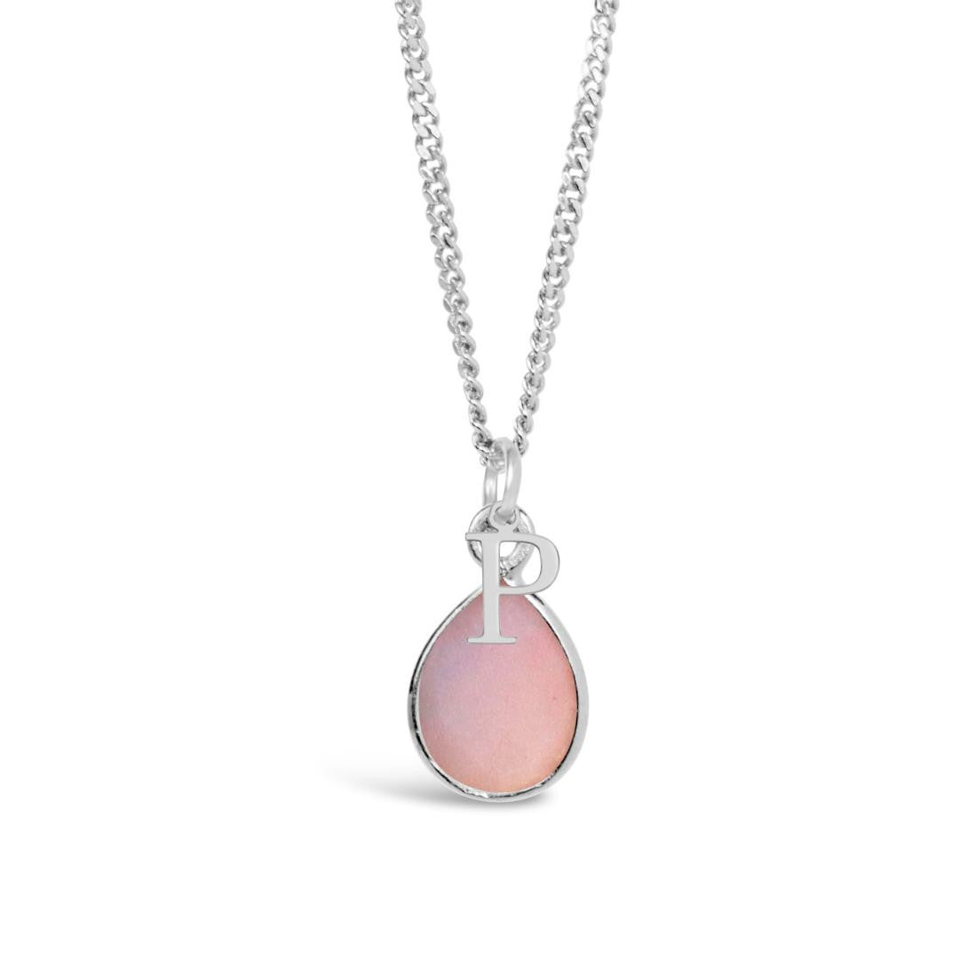 pink opal charm necklace in silver with initial charm on a white background