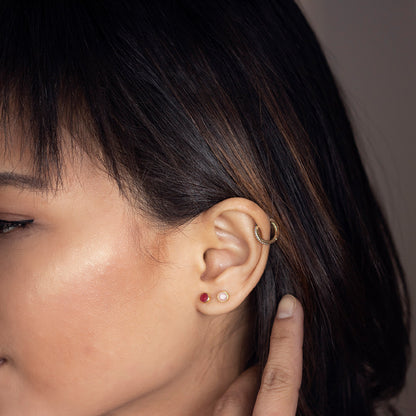 close up of model wearing pink opal stud earrings in silver