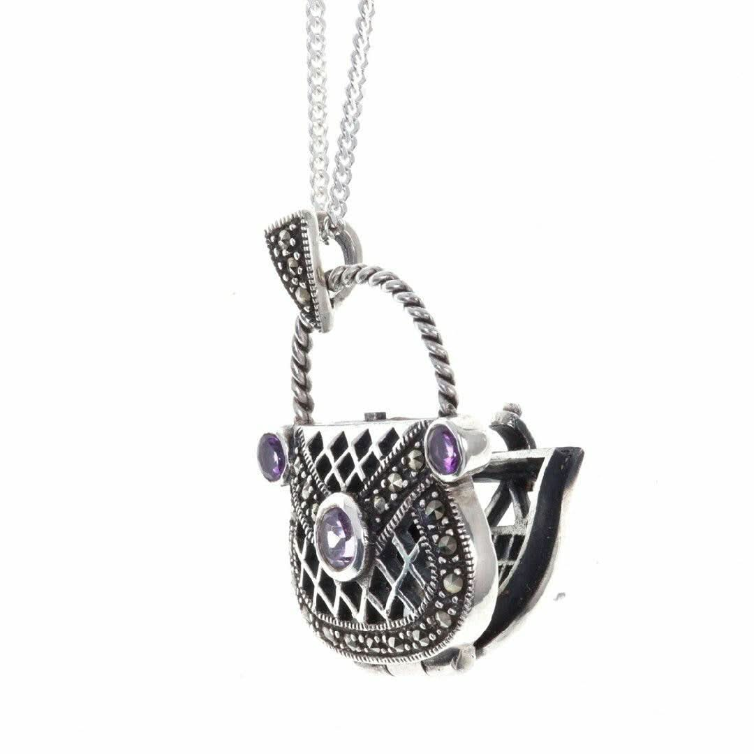 opened amethyst handbag locket on a white background