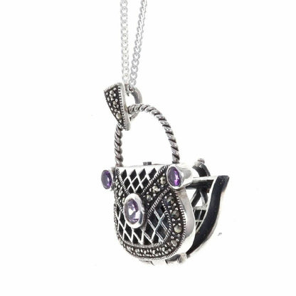 opened amethyst handbag locket on a white background