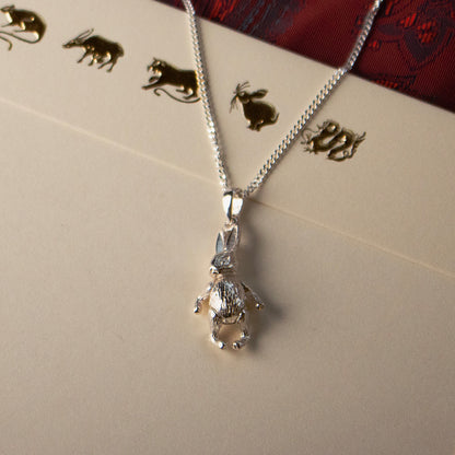 rabbit pendant in silver on a grey background