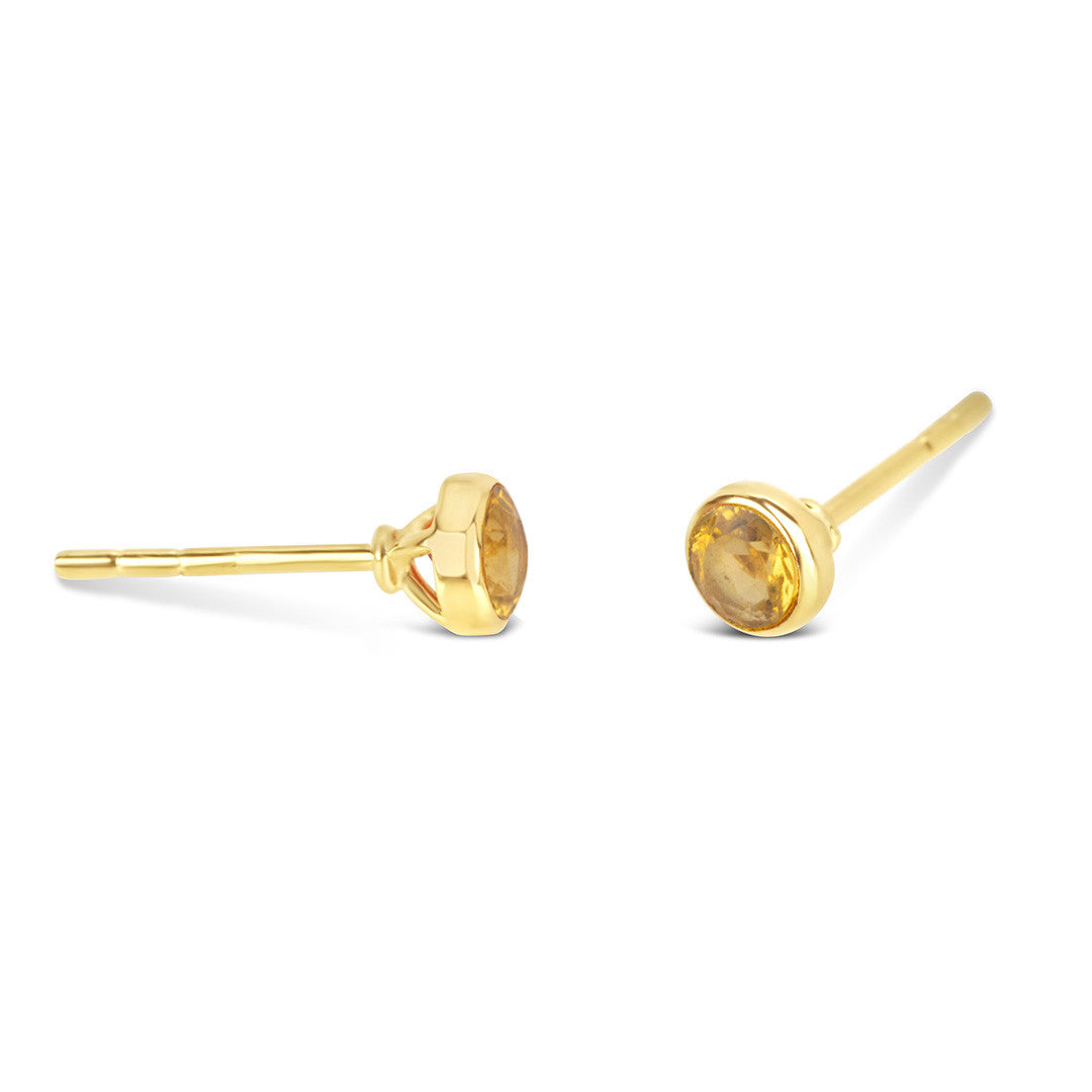 Citrine mini stud earrings in gold facing the side on a white background