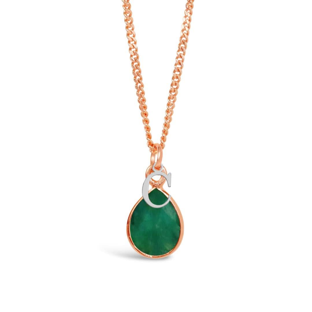emerald charm necklace in rose gold with silver initial charm on a white background
