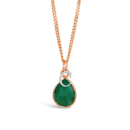 emerald charm necklace in rose gold with silver initial charm on a white background
