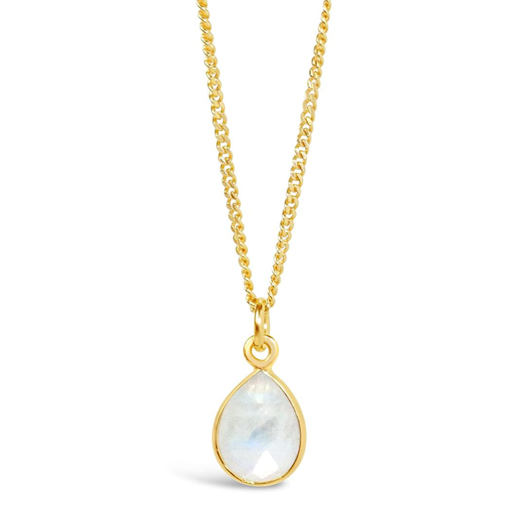 white quartz charm necklace in gold on a white background